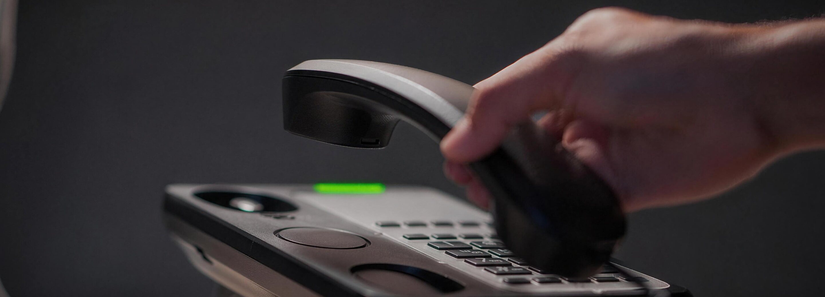 Hand picking up a telephone