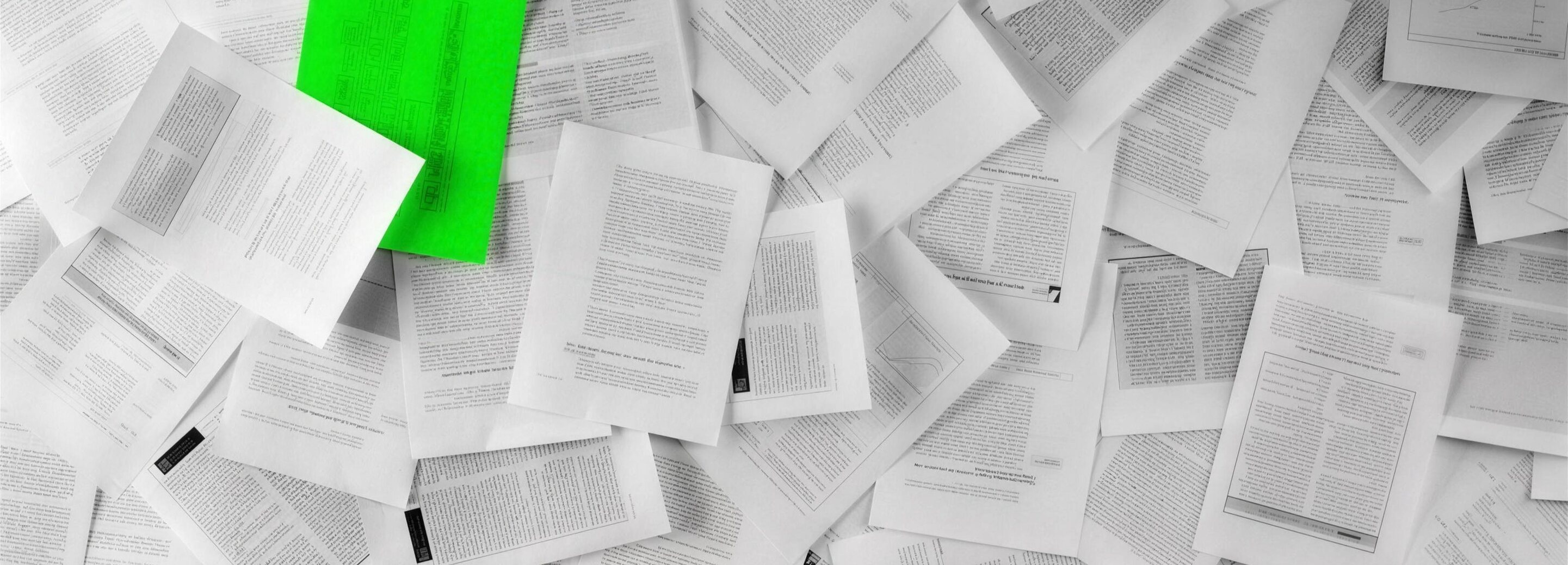 Pile of documents with a green sheet symbolising GDPR compliance