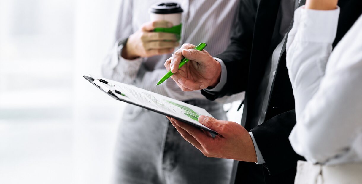 Hands holding a compliance checklist